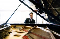 Alpin Hong seated at a piano